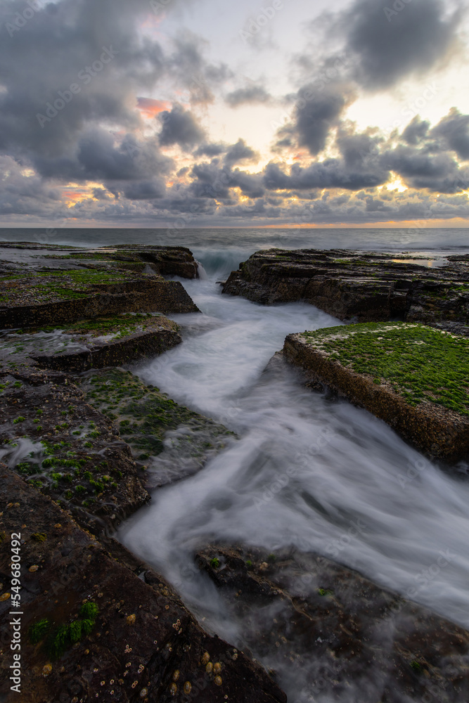 Wave water flowing between rocky channel.