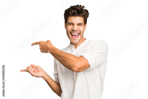 Obraz na plátně Young caucasian handsome man isolated excited pointing with forefingers away