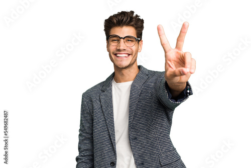 Young caucasian handsome man isolated joyful and carefree showing a peace symbol with fingers.