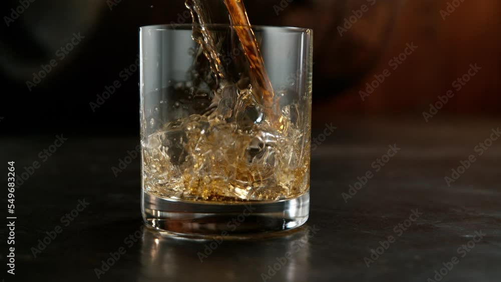 Super slow motion of pouring whiskey drink, camera motion. Filmed on high speed cinema camera, 1000 fps. Super slow motion of pouring whiskey drink, camera motion. Filmed on high speed cinema camera, 1000 fps.