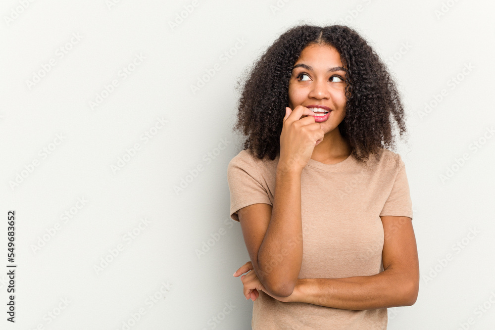 Young african american woman isolated on white background relaxed thinking about something looking at a copy space. Young african american woman isolated on white background relaxed thinking about something looking at a copy space.