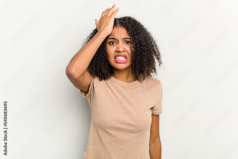 Young african american woman isolated on white background forgetting something, slapping forehead with palm and closing eyes. Young african american woman isolated on white background forgetting something, slapping forehead with palm and closing eyes.