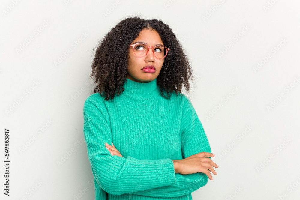 Young african american woman isolated on white background tired of a repetitive task. Young african american woman isolated on white background tired of a repetitive task.