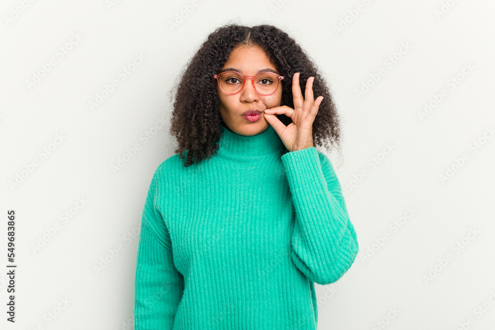 Young african american woman isolated on white background with fingers on lips keeping a secret. Young african american woman isolated on white background with fingers on lips keeping a secret.