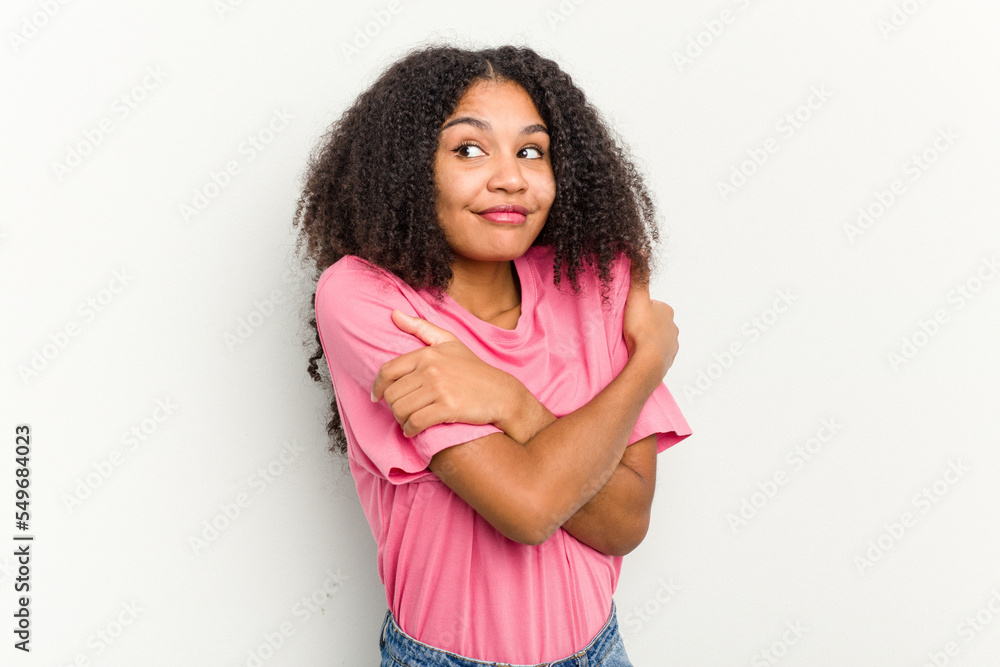 Young african american woman isolated on white background hugs, smiling carefree and happy. Young african american woman isolated on white background hugs, smiling carefree and happy.