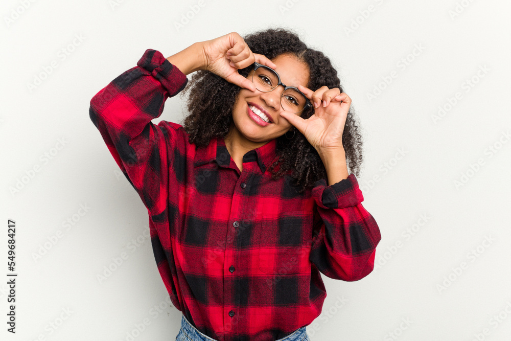 Young african american woman isolated on white background showing okay sign over eyes Young african american woman isolated on white background showing okay sign over eyes