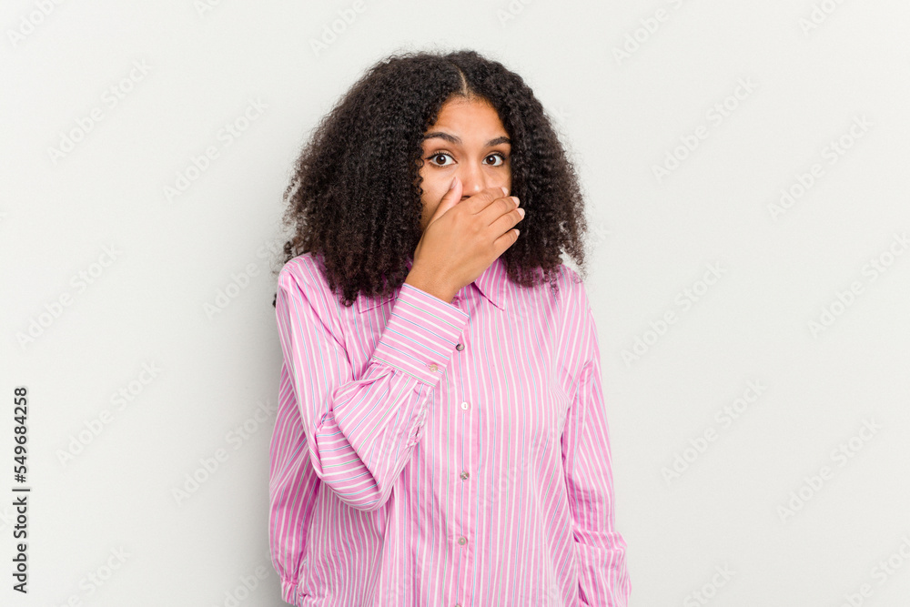 Young african american woman isolated on white background covering mouth with hands looking worried. Young african american woman isolated on white background covering mouth with hands looking worried.