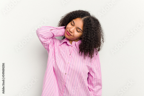 Young african american woman isolated on white background having a neck pain due to stress, massaging and touching it with hand. © Asier