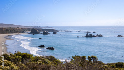 The beautiful west coast of California along Highway 1, with meadows and rocks, a blue sky and sea