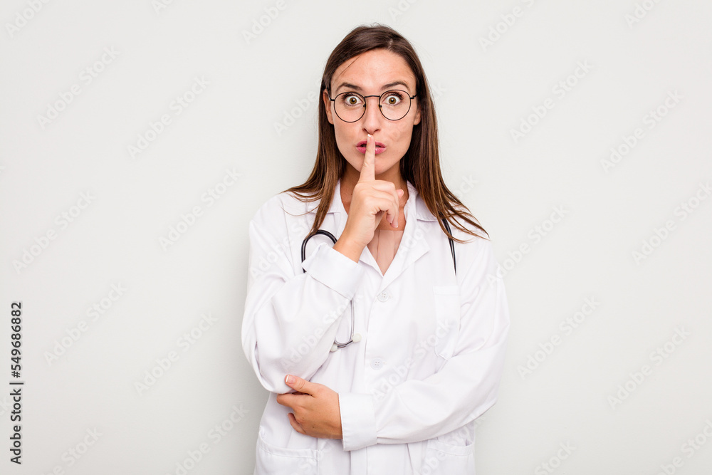 Young doctor woman isolated on white background keeping a secret or asking for silence. Young doctor woman isolated on white background keeping a secret or asking for silence.