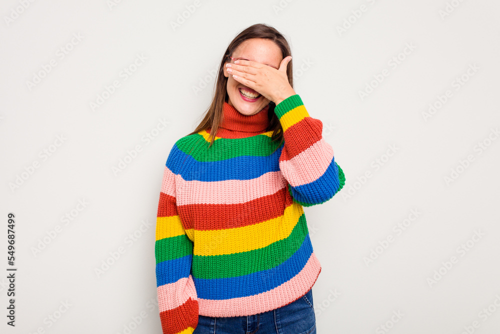 Young caucasian cute woman isolated on white background covers eyes with hands, smiles broadly waiting for a surprise. Young caucasian cute woman isolated on white background covers eyes with hands, smiles broadly waiting for a surprise.