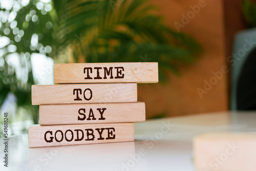Wooden blocks with words 'Time to say goodbye'. photo