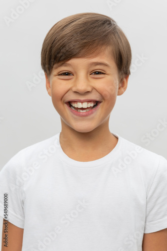 Portrait of smiling boy in a white t-shirt