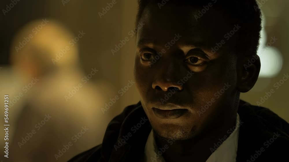 thoughts, problems - pensive black man raises his head and looks away sighing thoughts, problems - pensive black man raises his head and looks away sighing