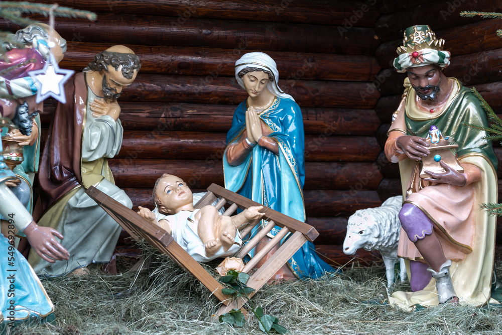Nativity scene with figurines of Jesus, Mary, Joseph, sheep and wise men.