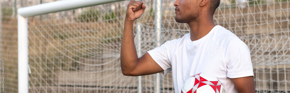 latin-soccer-player-with-ball-in-hand-celebrating-a-goal-concept-of-a