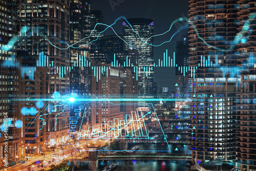 Illuminated aerial city panorama of Chicago Riverwalk downtown, Boardwalk, bridges, night time, Illinois, USA. Forex graph hologram. The concept of internet trading, brokerage and fundamental analysis