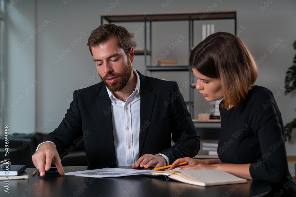 Serious businessman and businesswoman in formal suit discuss contract Serious businessman and businesswoman in formal suit discuss contract