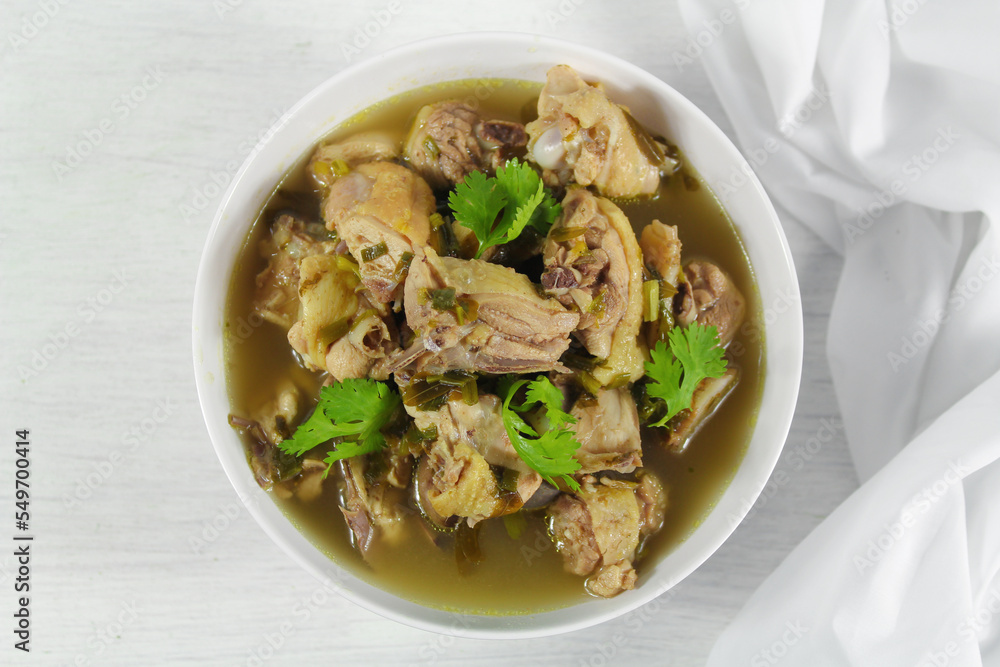 Homemade chicken soup with galangal, lemon grass in white bowl. Homemade chicken soup with galangal, lemon grass in white bowl.