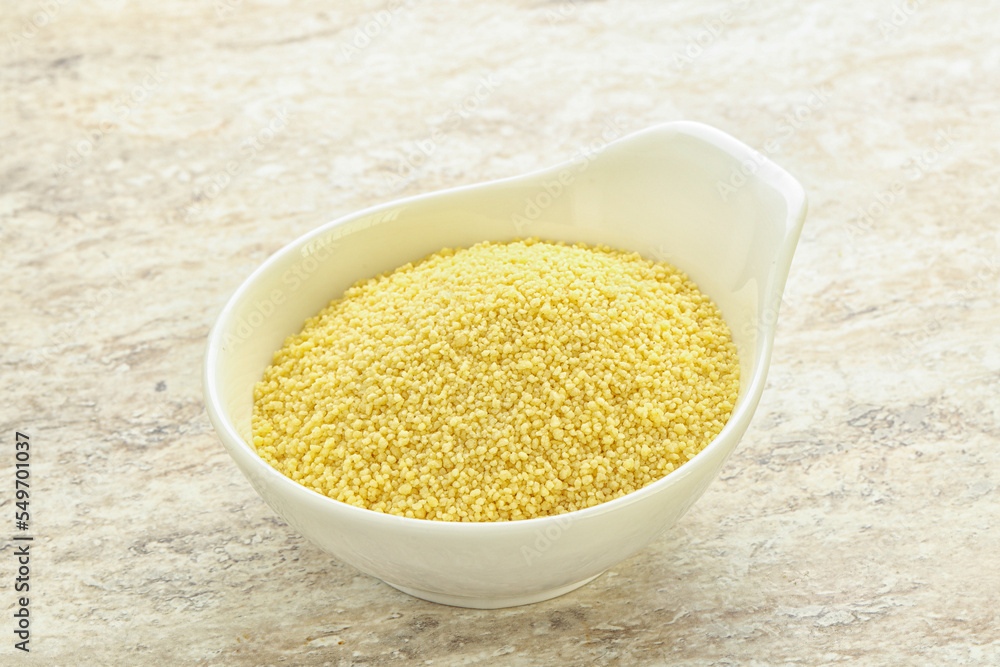 Raw couscous in the bowl Raw couscous in the bowl