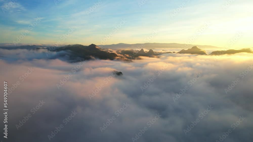 Drone flying over heavy dense fog during sunrise, Mountain scenery and sky in the background. amazing scenery in golden hour. Mae Hong Son Province, Northern Thailand. nature and travel concept. 4K
Drone flying over heavy dense fog during sunrise, Mountain scenery and sky in the background. amazing scenery in golden hour. Mae Hong Son Province, Northern Thailand. nature and travel concept. 4K