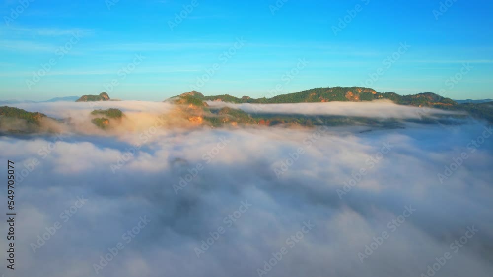 Drone flying over heavy dense fog during sunrise, Mountain scenery and sky in the background. amazing scenery in golden hour. Mae Hong Son Province, Northern Thailand. nature and travel concept. 4K
Drone flying over heavy dense fog during sunrise, Mountain scenery and sky in the background. amazing scenery in golden hour. Mae Hong Son Province, Northern Thailand. nature and travel concept. 4K