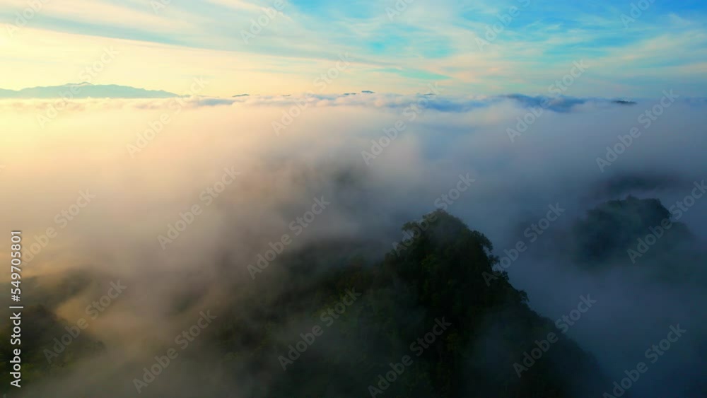 Drone flying over heavy dense fog during sunrise, Mountain scenery and sky in the background. amazing scenery in golden hour. Mae Hong Son Province, Northern Thailand. nature and travel concept. 4K
Drone flying over heavy dense fog during sunrise, Mountain scenery and sky in the background. amazing scenery in golden hour. Mae Hong Son Province, Northern Thailand. nature and travel concept. 4K