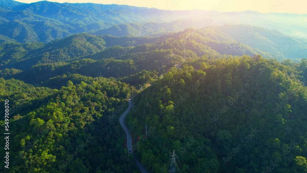 Top view above cars driving on winding road and high voltage poles in green tropical rainforest. countryside landscape. Thailand. Aerial view from a drone. transportation concept. natural background
Top view above cars driving on winding road and high voltage poles in green tropical rainforest. countryside landscape. Thailand. Aerial view from a drone. transportation concept. natural background
