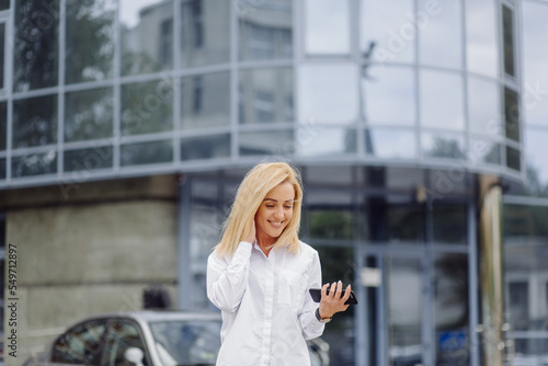 Business woman using the smart phone outside office center © andriyyavor