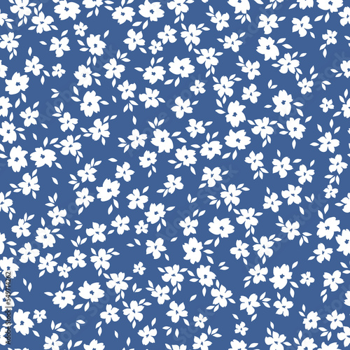 Cute floral pattern. Seamless vector texture. An elegant template for fashionable prints. Print with small white flowers and leaves. blue background.