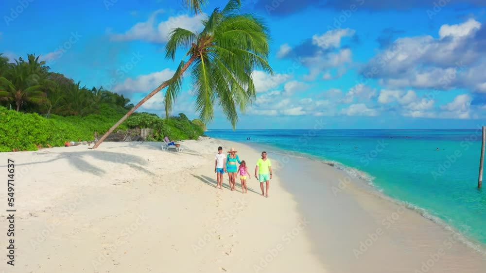Aerial view on family with two kids on tropical white sand beach with plam trees and azure sea in Maldives. Aerial view on family with two kids on tropical white sand beach with plam trees and azure sea in Maldives.
