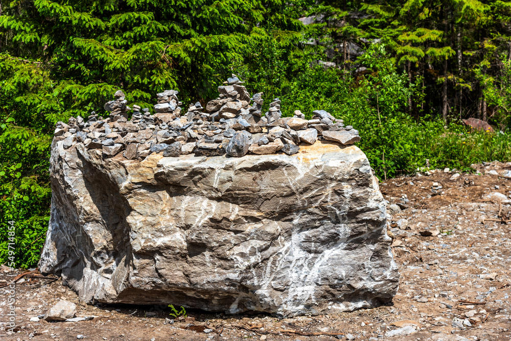 Pyramids of stones in Karelia. Pyramids of stones on background of green forest. Natural stones on top of each other. Balancing stones in the forest. Pyramids of stones in Karelia. Pyramids of stones on background of green forest. Natural stones on top of each other. Balancing stones in the forest.