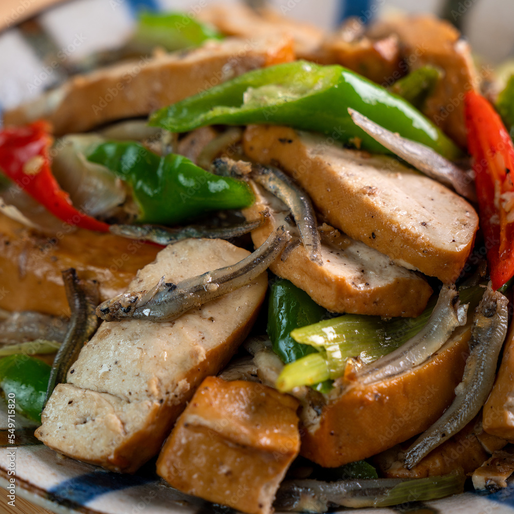 Homemade stir-fried dried beancurd with dried fish and green chili. Homemade stir-fried dried beancurd with dried fish and green chili.