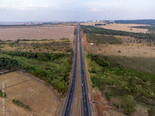 large highway in dry grass scenery amidst the farms