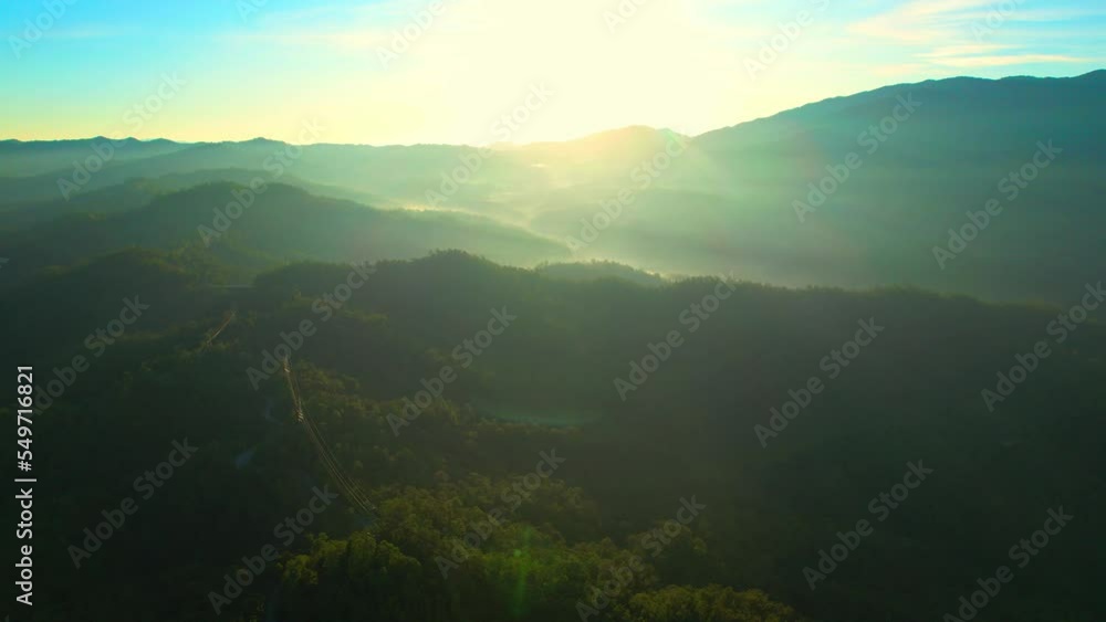 Aerial view over green valley in tropical forest during sunrise, Northern Thailand, Southeast Asia. The beauty of nature and geology. Travel in Thailand. Nature and ecosystem concept. 4K Drone.
Aerial view over green valley in tropical forest during sunrise, Northern Thailand, Southeast Asia. The beauty of nature and geology. Travel in Thailand. Nature and ecosystem concept. 4K Drone.