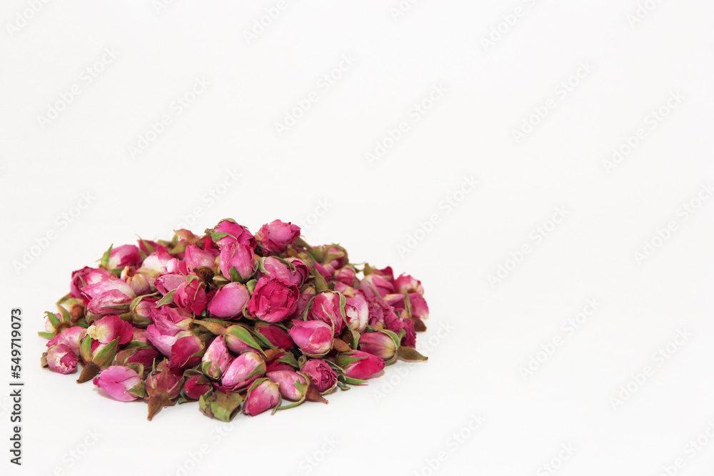small dry buds of natural pink rose for brewing fragrant tea, isolate on a white background