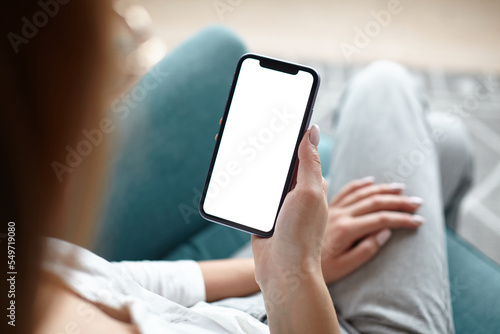 Mock up white screen blank mobile phone in woman hands holding Back view