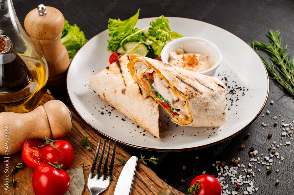 Tasty dish of pita with meat and vegetables on wooden background Tasty dish of pita with meat and vegetables on wooden background