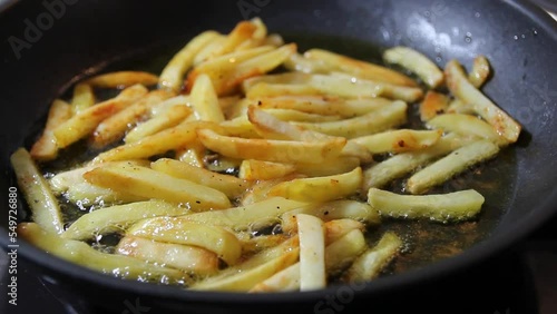 Cooking potato french fries in olive oil