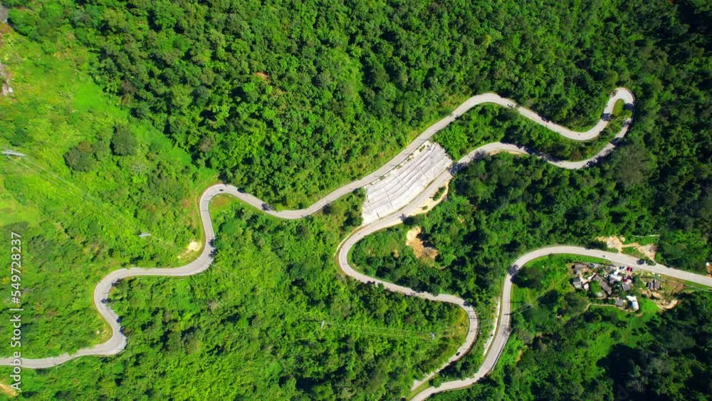 Aerial view over the mountain winding road, amazing road in the green tropical forest. Thailand, Southeast Asia. tourism and travel concept. Natural texture background. Drone 4K video
Aerial view over the mountain winding road, amazing road in the green tropical forest. Thailand, Southeast Asia. tourism and travel concept. Natural texture background. Drone 4K video
