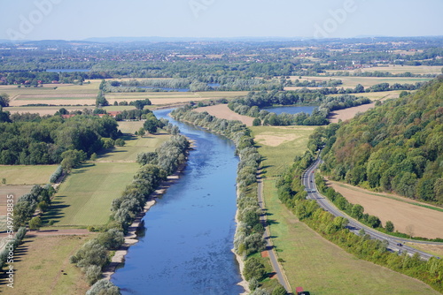 View of the landscape and the Weser from the Porta-Kanzel in Porta Westfalica. Green nature with a river, fields and hills.  © Elly Miller