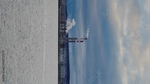 View of the tall chimneys of an industrial enterprise with a chimney polluting the atmosphere. The plant for the production of strategic intercontinental missiles 