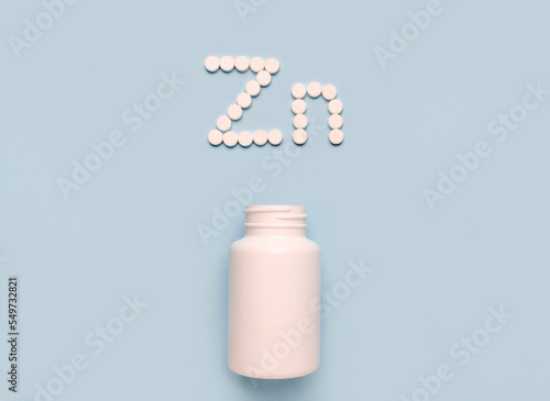 Chemical element Zinc Zn icon from tablets and drug bottle on blue background. Colltction of vitamin and minerals