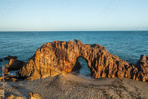 Aerial view of a natural arch along the coast in Jericoacoara, State of Ceara, Brazil. photo