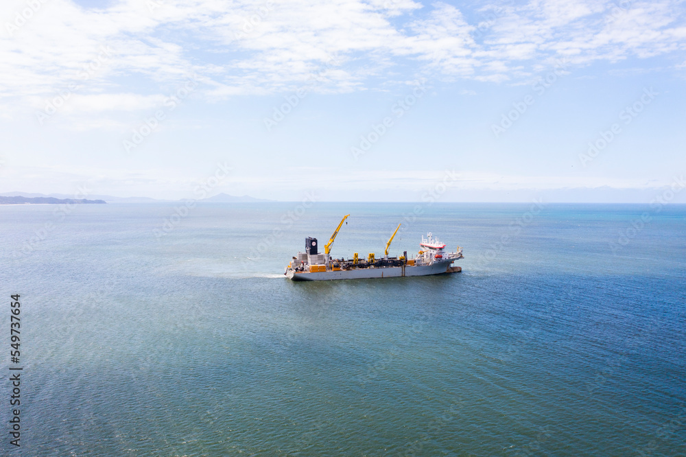 Aerial view of beach nourishment boat at the bay of Balneário Camboriú, Brazil. Aerial view of beach nourishment boat at the bay of Balneário Camboriú, Brazil.