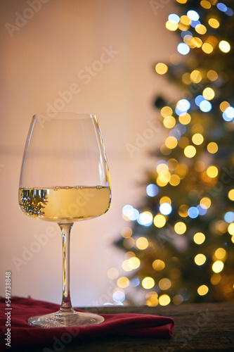 Glass of White Wine and Christmas Tree Lights