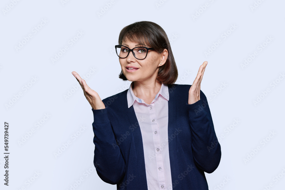 Middle aged business woman talking looking at camera on white background Middle aged business woman talking looking at camera on white background