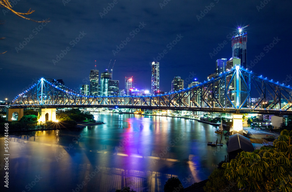 The 'Storey Bridge' spanning the River Brisbane with cityscape illuminated at night 