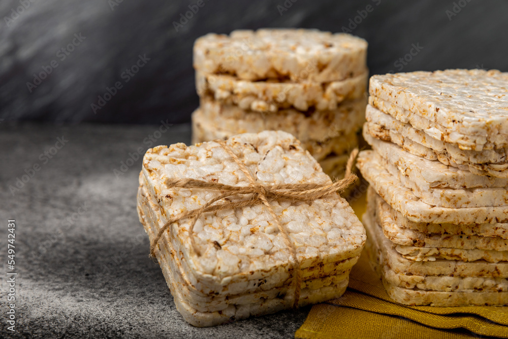 Rice cakes on a black table. Bread. Airy rice bread. dietary crispy round rice cakes. Place for text. Place to copy. Healthy food. dietary product. Rice cakes on a black table. Bread. Airy rice bread. dietary crispy round rice cakes. Place for text. Place to copy. Healthy food. dietary product.