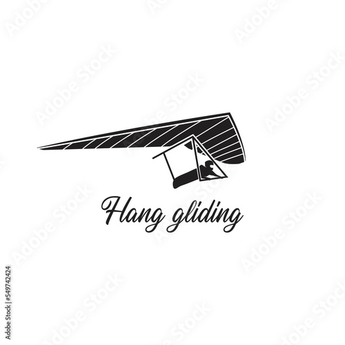 Black isolated silhouette of hang glider on white background.